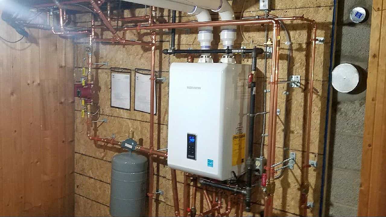 Kelowna plumbing and heating experts installing a Navien combi boiler system.